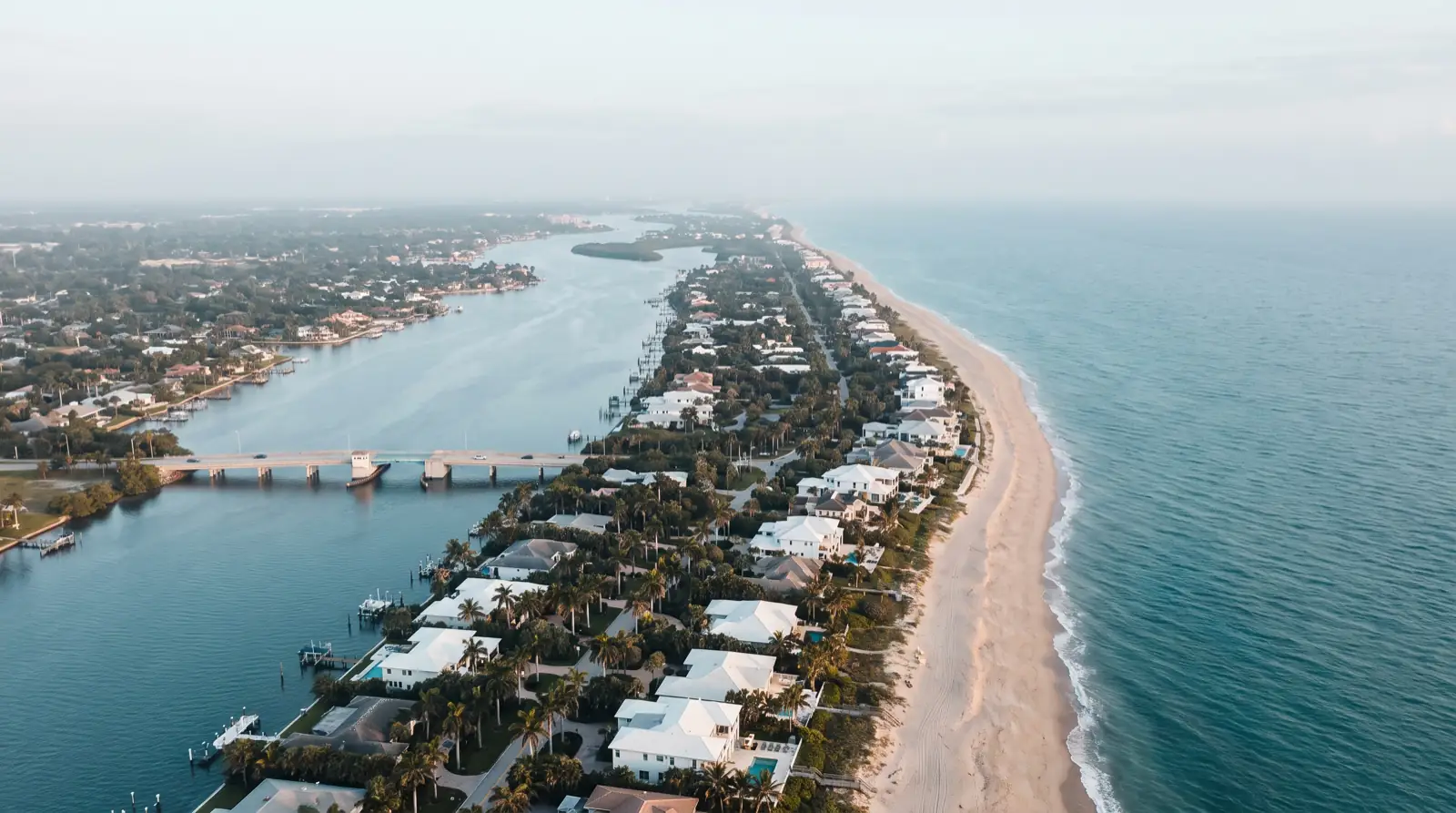 An aerial view of a Treasure Coast barrier island between the Atlantic and the Intracoastal Waterway — representative of the coast Sterling serves (illustrative)